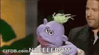 Man Holding Purple Puppet Saying Neeeeerom GIF