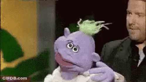 Man Holding Purple Puppet With Green Hair GIF