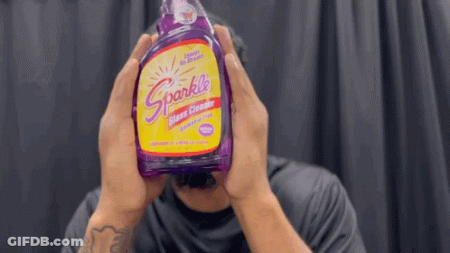 Man Holding Purple Sparkle Glass Cleaner GIF