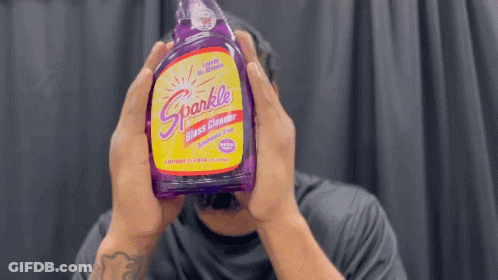 Man Holding Purple Sparkle Glass Cleaner GIF