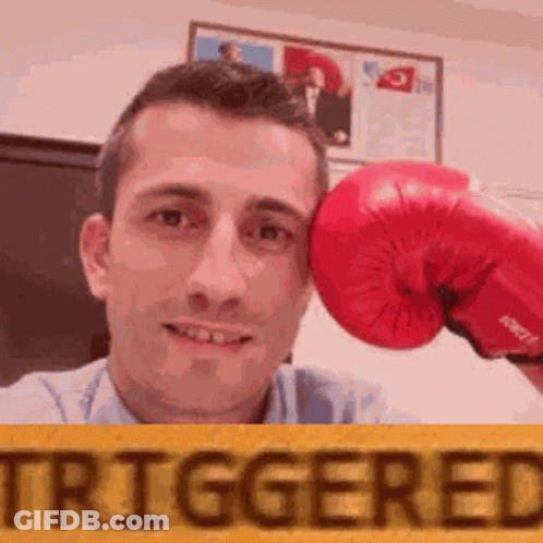 Man Holding Red Boxing Glove To Forehead GIF
