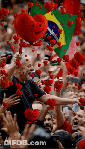 Man Holding Red Heart With Face Before Crowd GIF