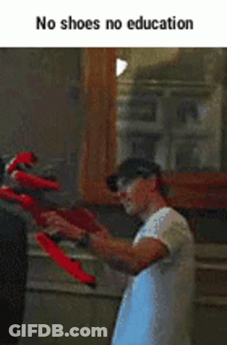 Man Holding Red Shoes GIF