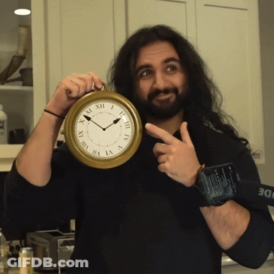 Man Holding Roman Numeral Clock GIF