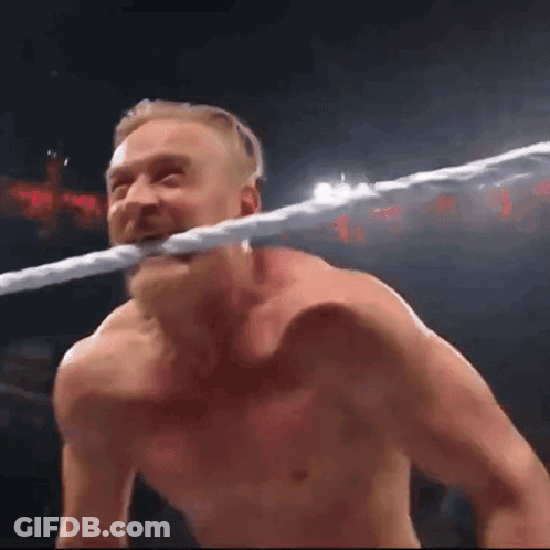 Man Holding Rope In Mouth In Wrestling Ring GIF
