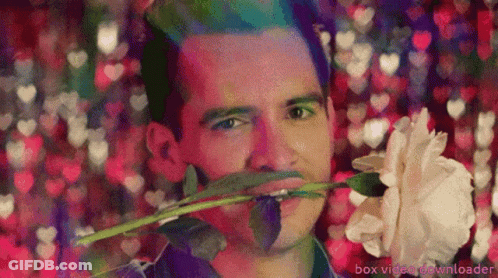 Man Holding Rose In Mouth Box Video Downloader GIF