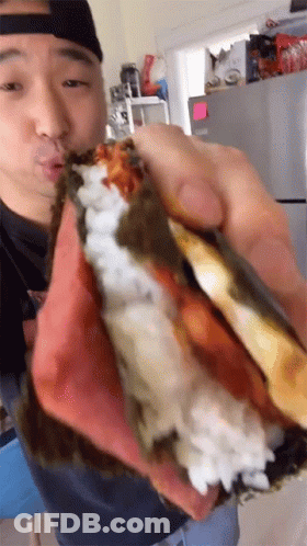 Man Holding Sandwich With Rice And Meat GIF