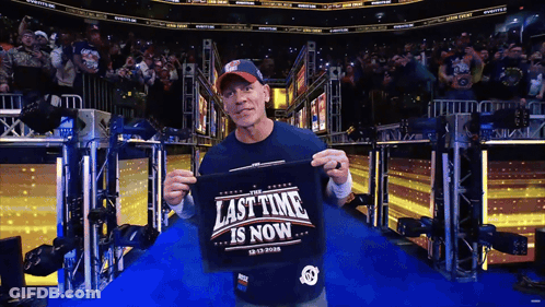 Man Holding Shirt Saying Last Time Is Now GIF