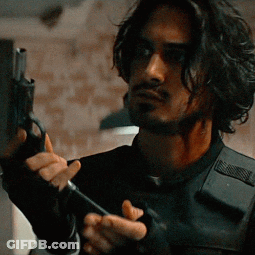 Man Holding Shotgun In Front Of Resident Evil Sign GIF