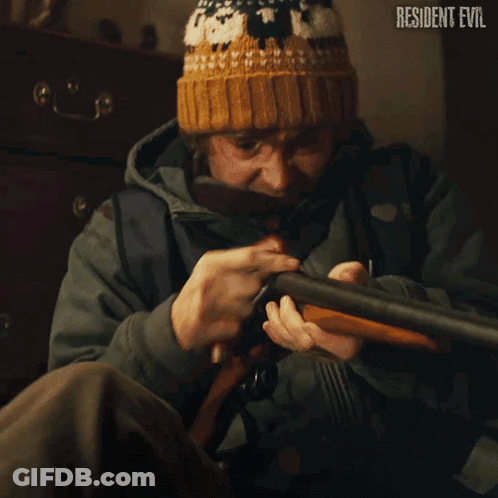 Man Holding Shotgun In Front Of Resident Evil Sign GIF