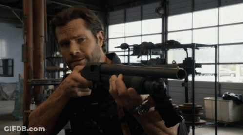 Man Holding Shotgun In Garage GIF
