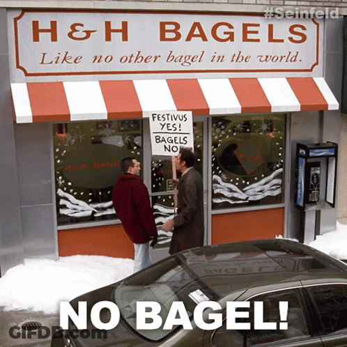 Man Holding Sign Saying Festivus Yes Bagel No GIF