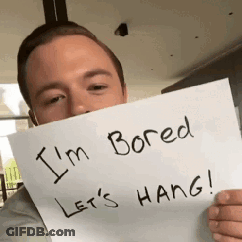 Man Holding Sign Saying I'm Bored Let's Hang GIF