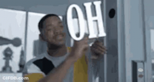 Man Holding Sign Saying Oh On Wall GIF