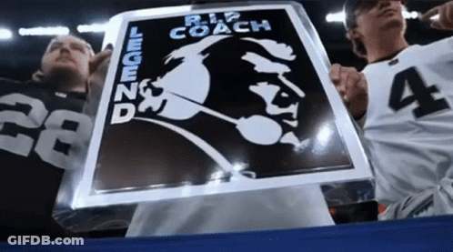 Man Holding Sign Saying Rip Coach Legend GIF