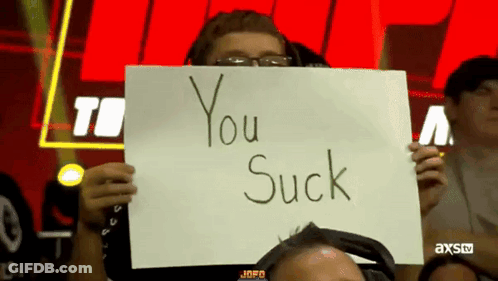 Man Holding Sign Saying You Suck GIF