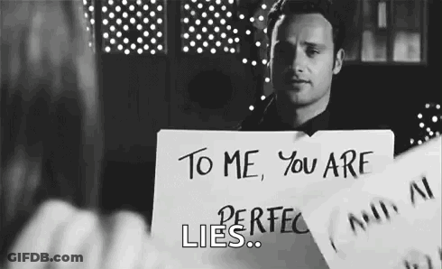 Man Holding Sign That Says You Are Perfect Lies GIF