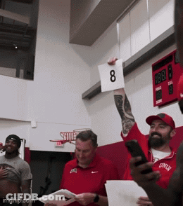 Man Holding Sign With Number 8 GIF