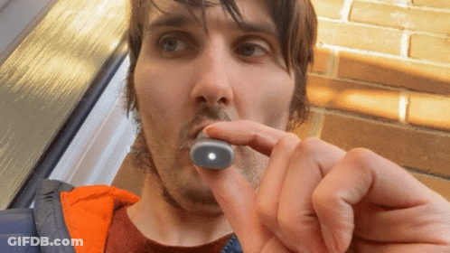Man Holding Small Object With Light In Mouth GIF