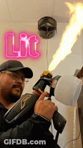 Man Holding Spray Gun In Front Of Neon Sign GIF