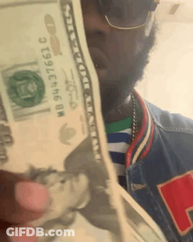 Man Holding Stack Of Money With Bill Saying NB943736610 GIF