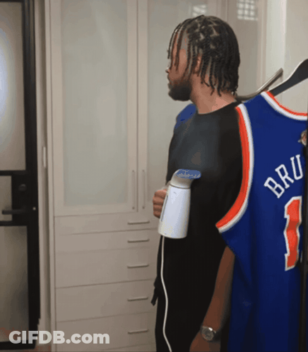 Man Holding Steamer Next To Bru Jersey GIF