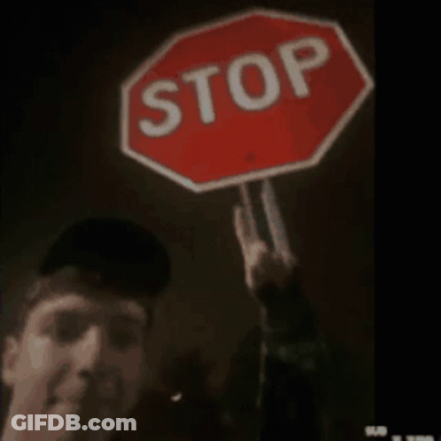 Man Holding Stop Sign Making Peace Sign GIF
