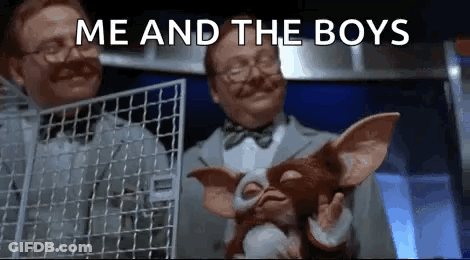 Man Holding Stuffed Animal In Cage While Another Holds Fence GIF