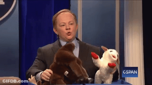 Man Holding Stuffed Animals In Front Of C-SPAN Sign GIF