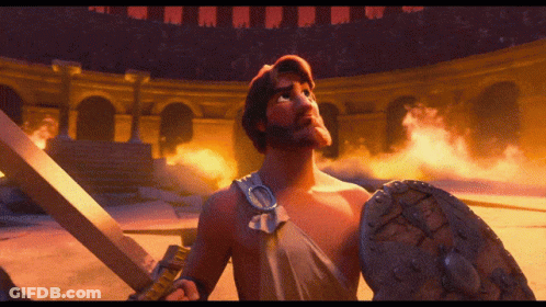 Man Holding Sword And Shield In Front Of Arena GIF