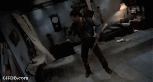 Man Holding Sword In Dark Room GIF