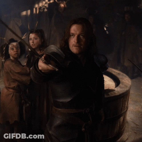 Man Holding Sword In Dark Room GIF