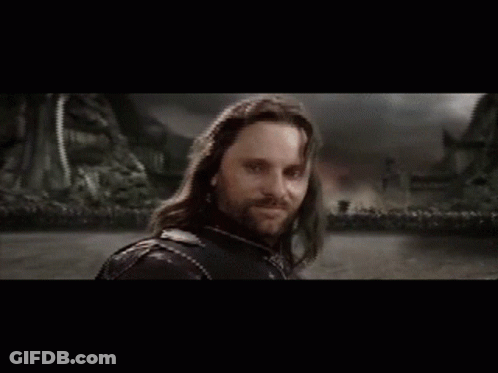 Man Holding Sword In Front Of Castle GIF