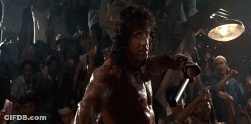 Man Holding Sword In Front Of Crowd GIF