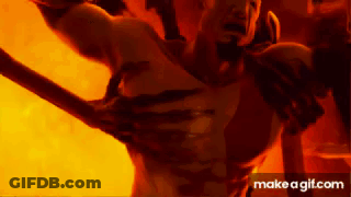 Man Holding Sword In Front Of Fire Says Make A GIF