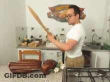 Man Holding Sword In Front Of Mattel Sign GIF