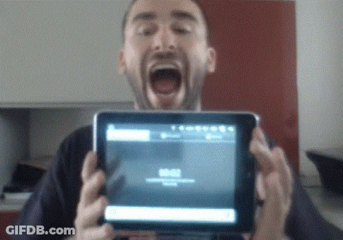 Man Holding Tablet With Mouth Open Showing 00:00 GIF