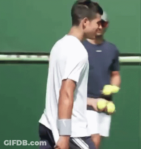 Man Holding Tennis Racket On Tennis Court GIF