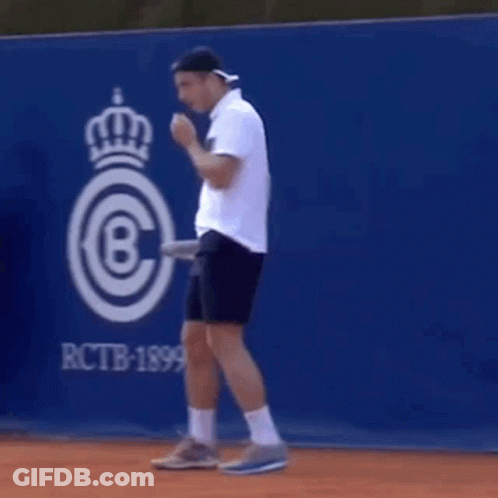 Man Holding Tennis Racket On Tennis Court GIF
