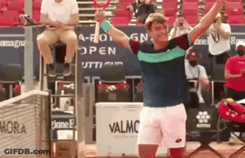 Man Holding Tennis Racquet And Man Sitting GIF