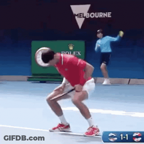 Man Holding Tennis Racquet As Another Throws Ball GIF
