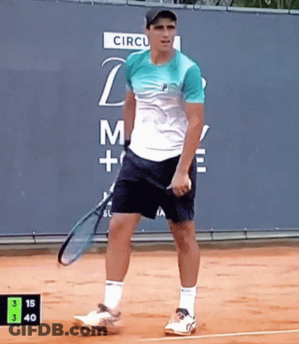 Man Holding Tennis Racquet In Front Of Circul Sign GIF