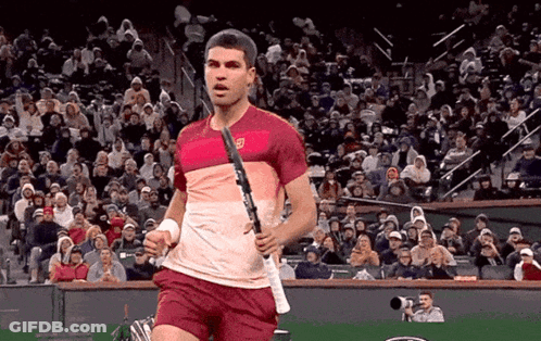 Man Holding Tennis Racquet In Front Of Crowd GIF