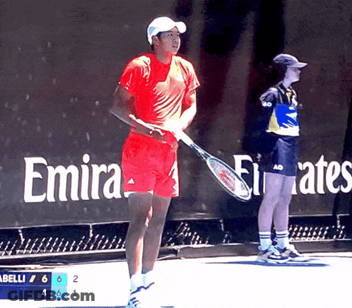 Man Holding Tennis Racquet In Front Of Emirates Ad GIF