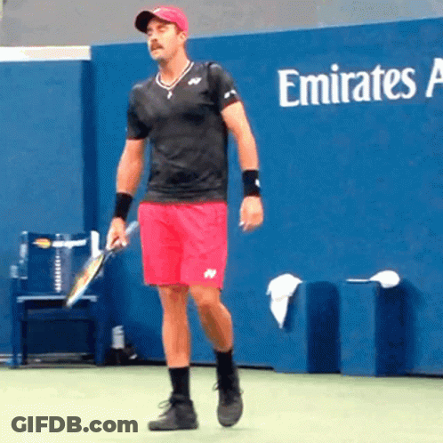 Man Holding Tennis Racquet In Front Of Emirates Advertisement GIF