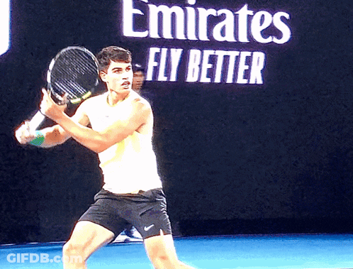 Man Holding Tennis Racquet In Front Of Emirates Fly Better Sign GIF