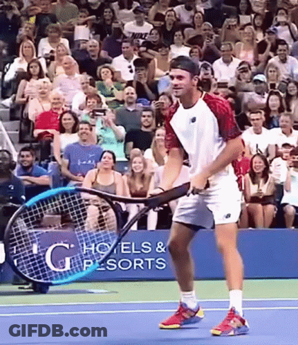 Man Holding Tennis Racquet In Front Of G Hotels & Resorts Sign GIF