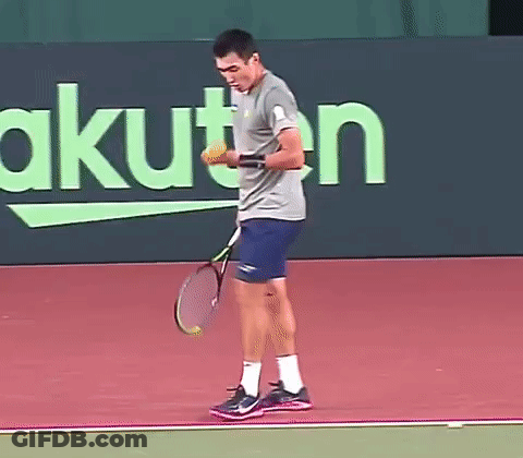 Man Holding Tennis Racquet In Front Of Rakuten Sign GIF