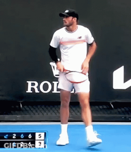 Man Holding Tennis Racquet In Front Of Rolex Sign GIF