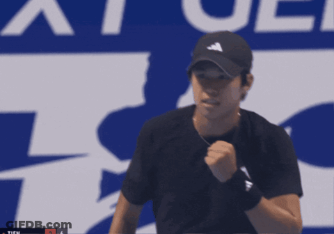 Man Holding Tennis Racquet In Front Of Ticu Sign GIF